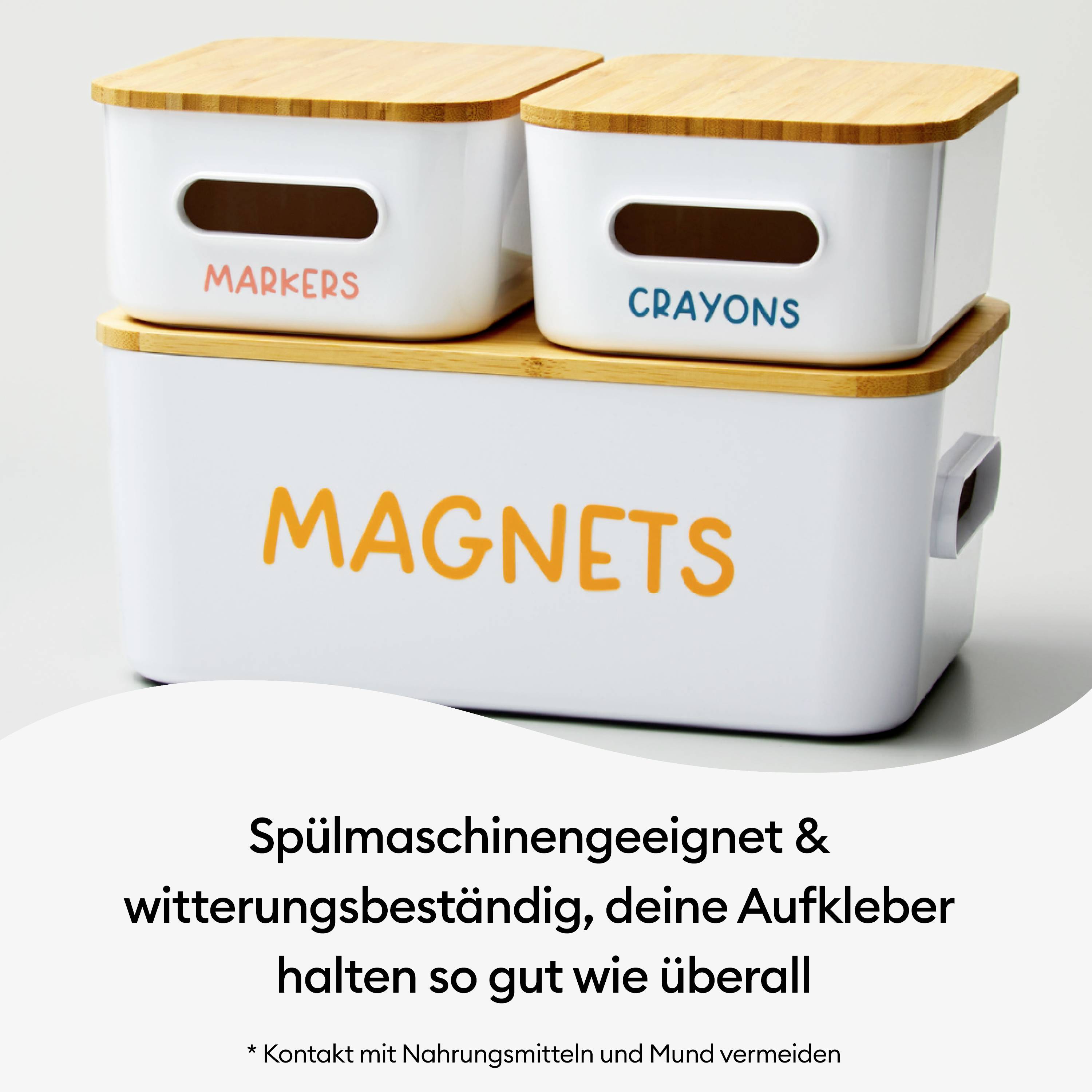 White storage boxes with wooden lids, labelled with 'Markers', 'Crayons' and 'Magnets'. Text explains the durability of the labels.