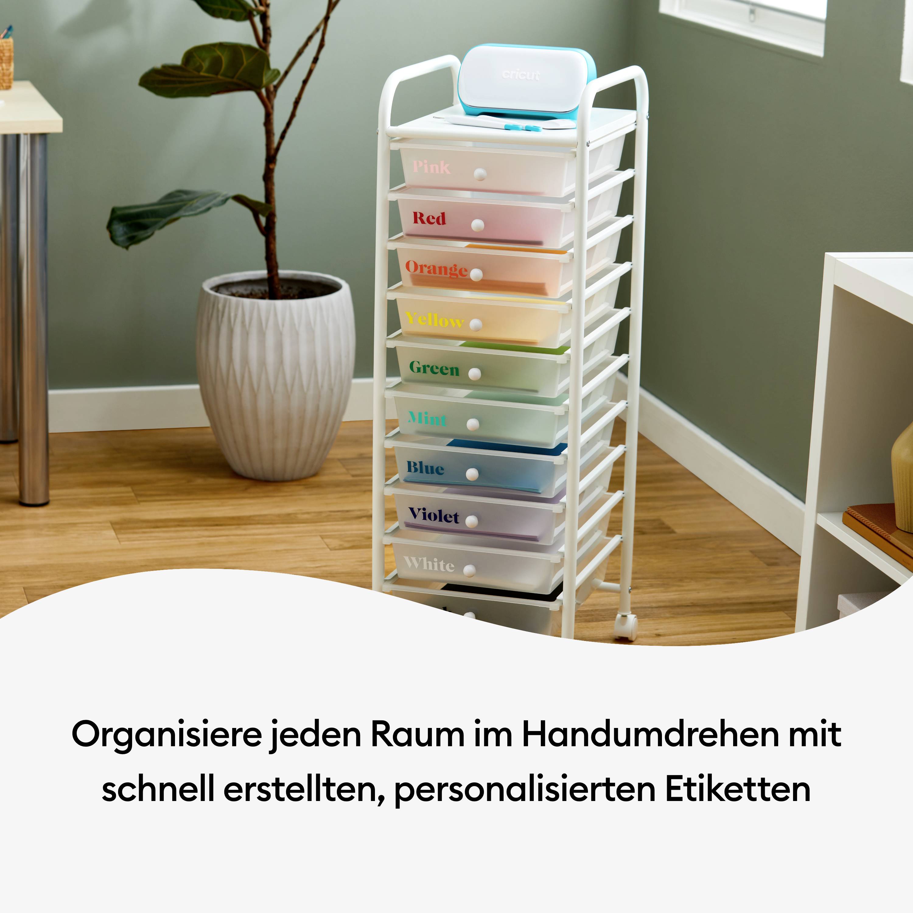 A white trolley with colourful, labelled compartments stands in a room next to a plant. Text: 'Organise Every Room'.