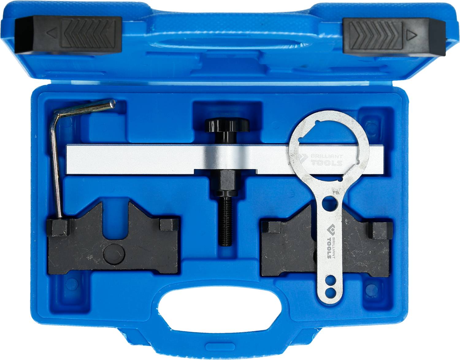 A blue tool case contains specialised tools for motor repair: a holder, a spanner, and two black blocks.