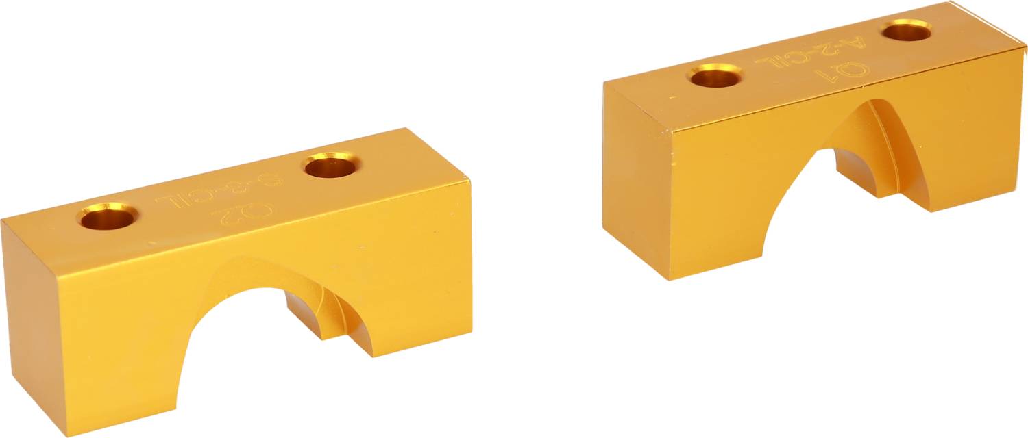 Two yellow metal blocks with holes and semi-circular recesses. The left block displays the inscription 'N2325', the right one '1042'.