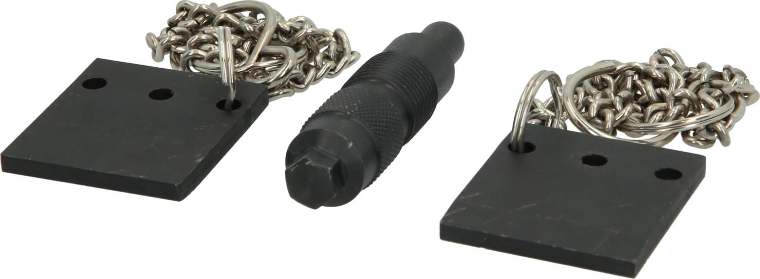 Two rectangular black metal plates with holes, connected by metal chains, beside a black cylindrical handled tool.
