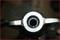Close-up of a metal structure with a central circular hole and side levers, potentially part of a mechanical device.