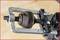 A close-up of a universal joint secured in a metal device, likely in a mechanical workshop.