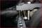 'Close-up of a metal frame with bolts and screws, held by two black gloves. Focus on the assembly.'