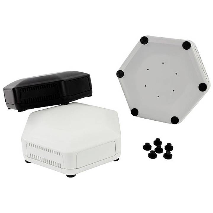 A white, hexagonal electronic device with black feet is pictured, with separate black components lying beside it.