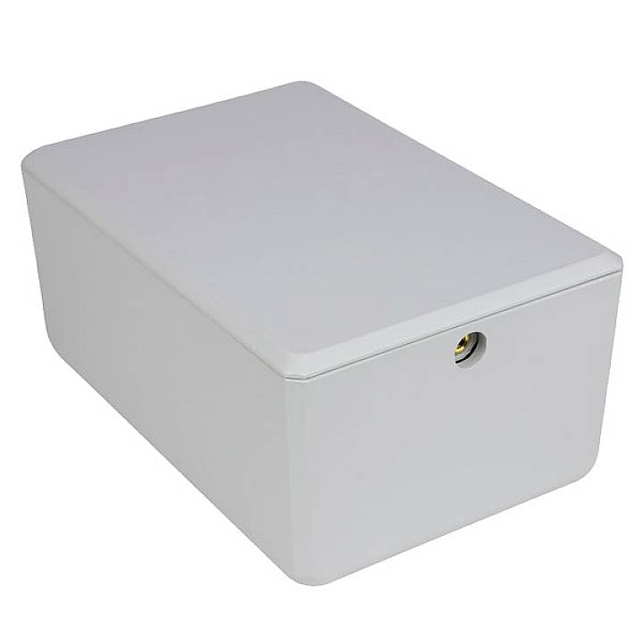 A rectangular, grey enclosure with rounded edges and a small round hole on the front, mountable or usable as a cover.