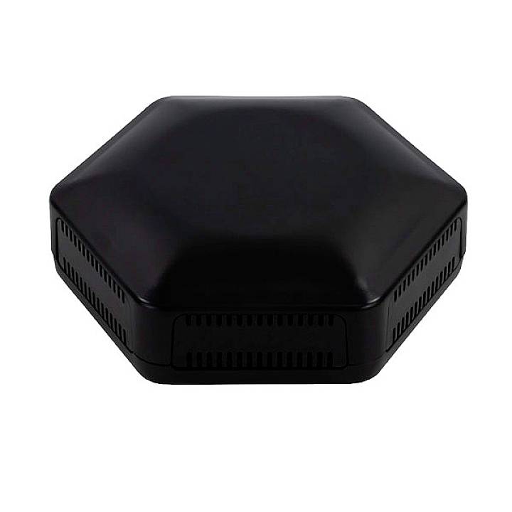 A black, hexagonal electronic device on a white background. It has ventilation slots on its sides.