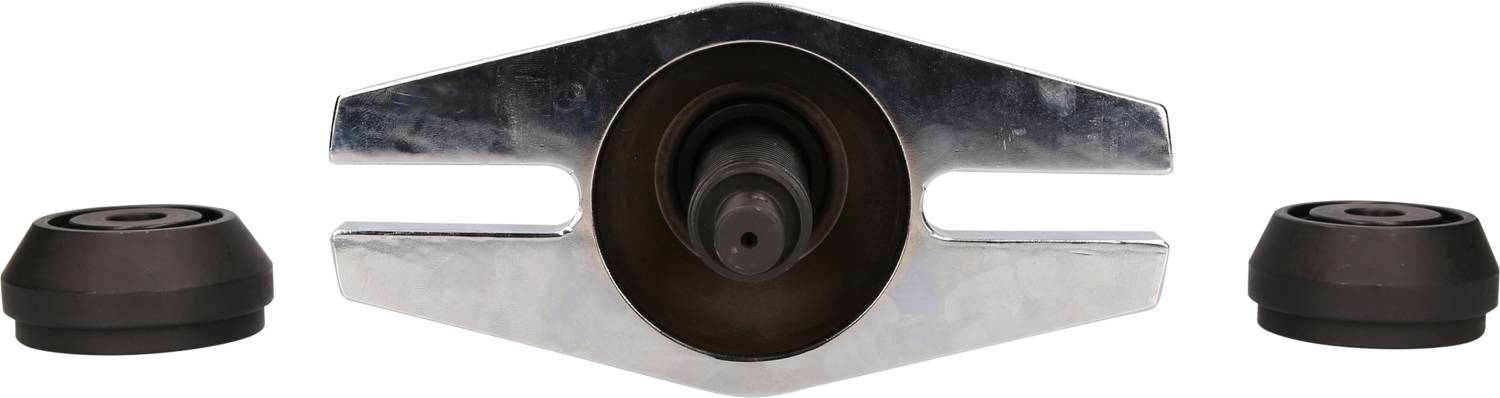 Metal tool with a central hole and two rounded end caps. Possibly used for assembly or repair work.