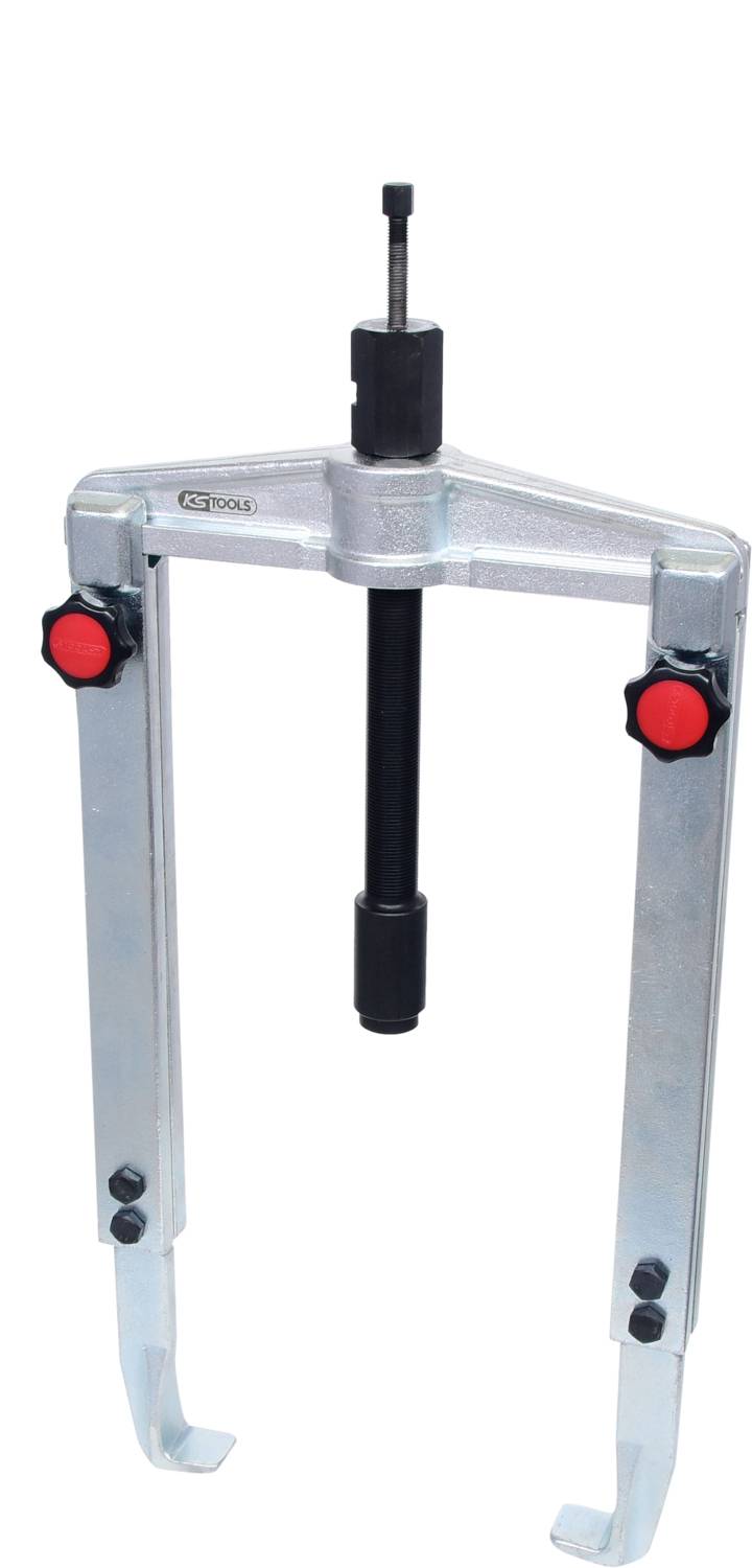 A silver two-arm puller with red handles, used for removing bearings or gears from a shaft.