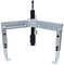 A three-legged puller with hooks for removing bearings or gears. Metallic tool with adjustable tensioning mechanism.
