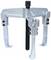 A mechanical three-arm puller in silver, used for removing tight-fitting parts such as gears or bearings from a shaft.