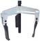 Three-legged puller with adjustable jaws and central screw, used for removing stuck parts such as gears.