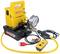 Hydraulic pump with a yellow casing, pressure gauge and mains plug by the brand 'KS Tools'. Used for pressure generation in workshops.