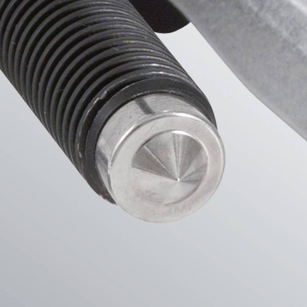 Close-up of a metal bolt with ridged threads, appearing to be part of a mechanical device. Smooth, shiny surface.