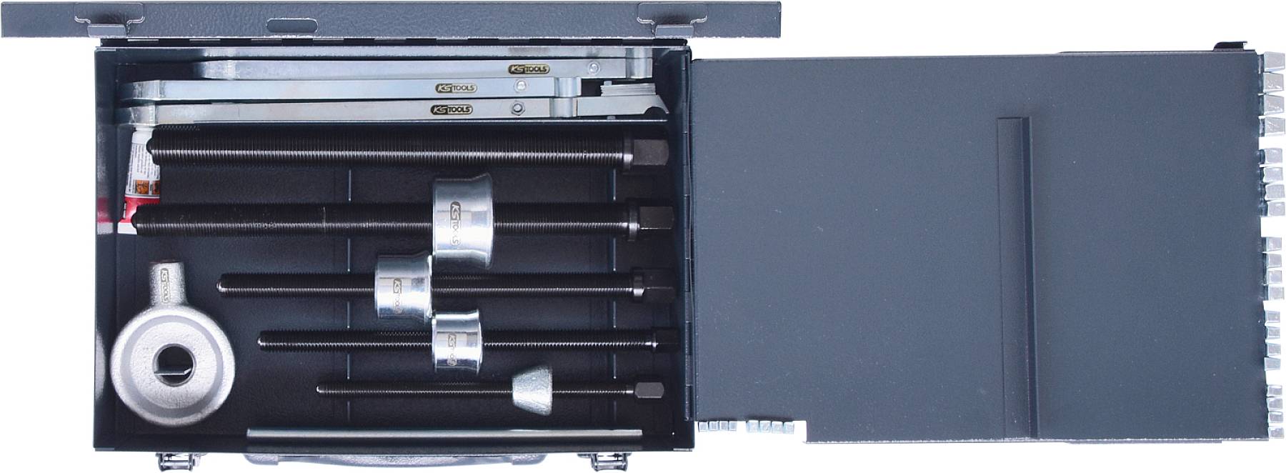 An open toolbox with various metallic screwing tools and accessory parts in padded compartments.