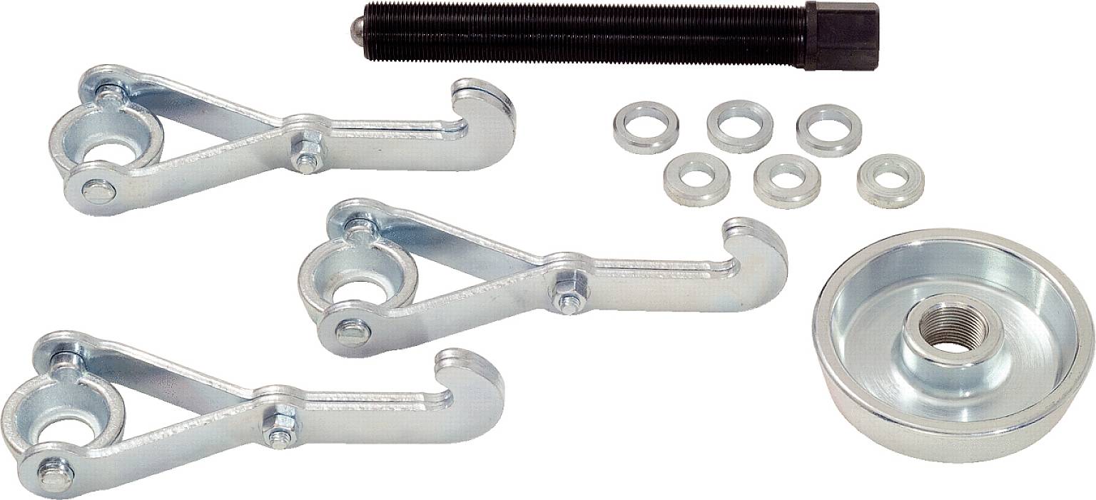 A puller set with several metal components, including three gripper arms, a threaded bolt, multiple washers, and a circular plate.