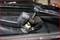 'Nut loosened on a windscreen wiper arm with a spanner.'
