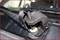 Close-up of a vehicle tool removing a windscreen wiper arm from a car. The tool is mounted on the joint.