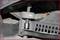 'Close-up of a tool for installing a V-belt. The tool tensions the belt to facilitate installation.'