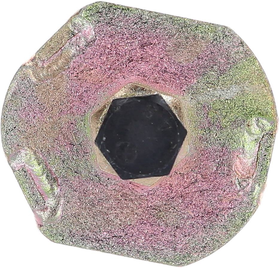 A hexagonal metal screw head with worn, colourful surface textures.