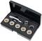A black set with six rings, a tap and an adaptor in a rectangular case for repairing oil drain plugs.