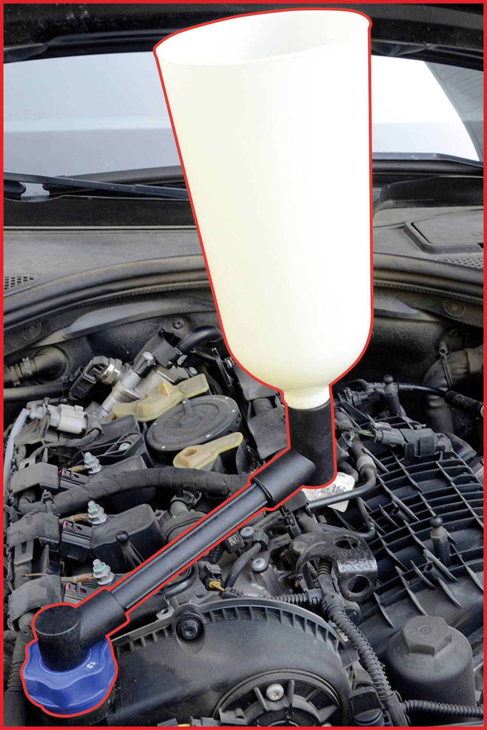 A funnel is attached to the filler neck of a car radiator to pour coolant cleanly. The engine compartment is visible.