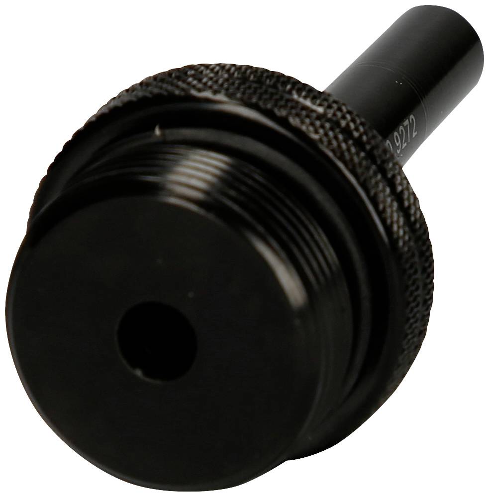 A black, cylindrical metal component with a grooved edge and a central hole, potentially a mechanical spare part.