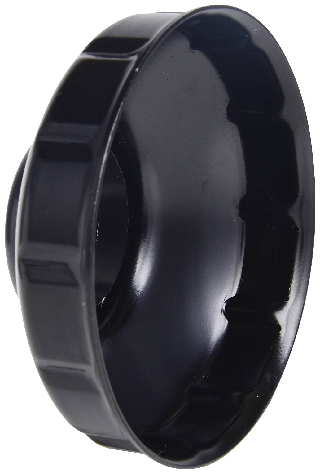 A black plastic oil filter cap spanner with ribbed edges, used for removing motor oil filters.