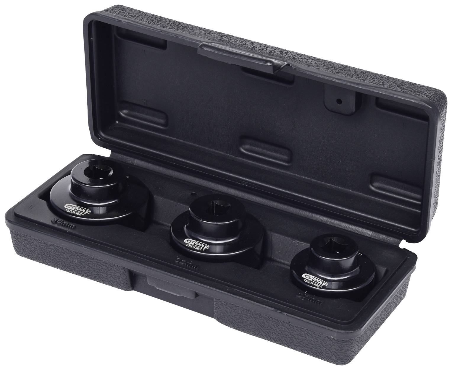 Black plastic case with open lid, containing three black adapters of different sizes in equally black recesses.