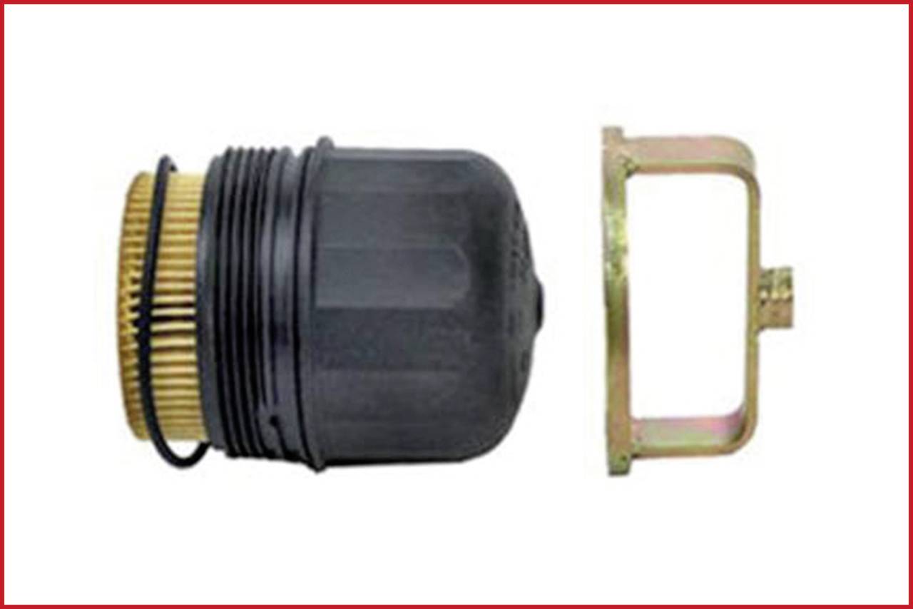 Black oil filter cap with yellow filter insert, alongside a gold-coloured metal mounting bracket.