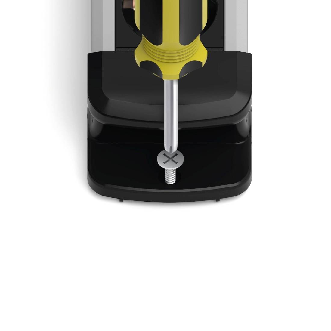 A yellow screwdriver tightens a screw into black material. Top-down view, close-up.