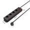 Black power strip with four sockets, each with an on/off switch. Length: 33 cm, Width: 7.5 cm, Cable: 5 cm long.