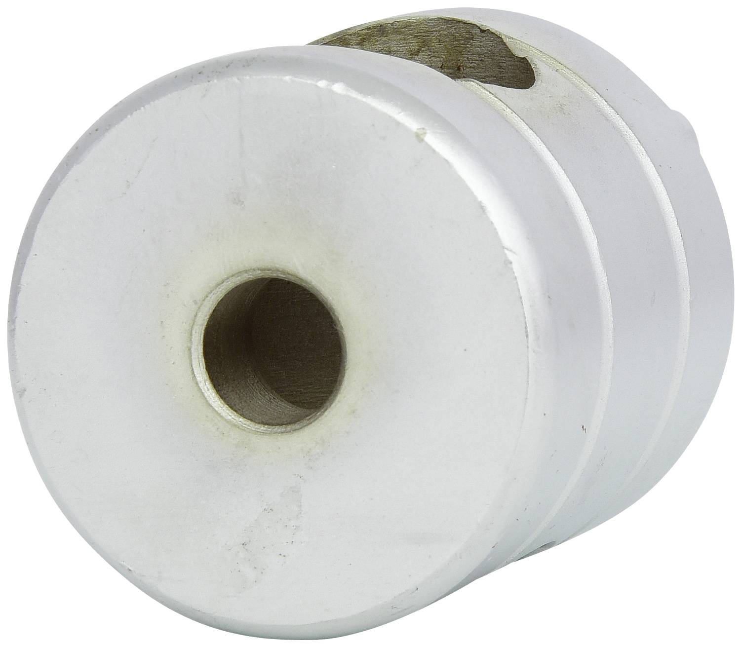 'Round, metallic door stop with a central hole, slightly worn.'