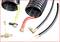 Several black spiral air hoses with coloured connectors and copper couplings, used for compressed air systems.
