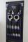 A black tool organiser board with multiple metal G-clamps in various sizes, neatly arranged.
