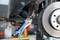 A vehicle joint pliers is attached to a screw component near an open car brake system.