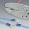 A crimping plier for insulated cable lugs lies next to two blue cable connectors.