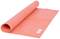 Orange yoga mat, partially unrolled, lying on a surface. A small label with the inscription 'YOGA STUDIO' is visible on top.