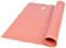 A red yoga mat, partially rolled up, lies flat on the floor. It has a rectangular shape and a smooth surface.
