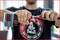 A person is holding a tool and connecting two parts together. A blurred window can be seen in the background.