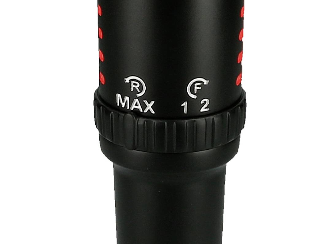 Close-up of a black device with red markings, a rotatable adjustment ring and the labels 'MAX', 'R', 'F', '1', '2'.