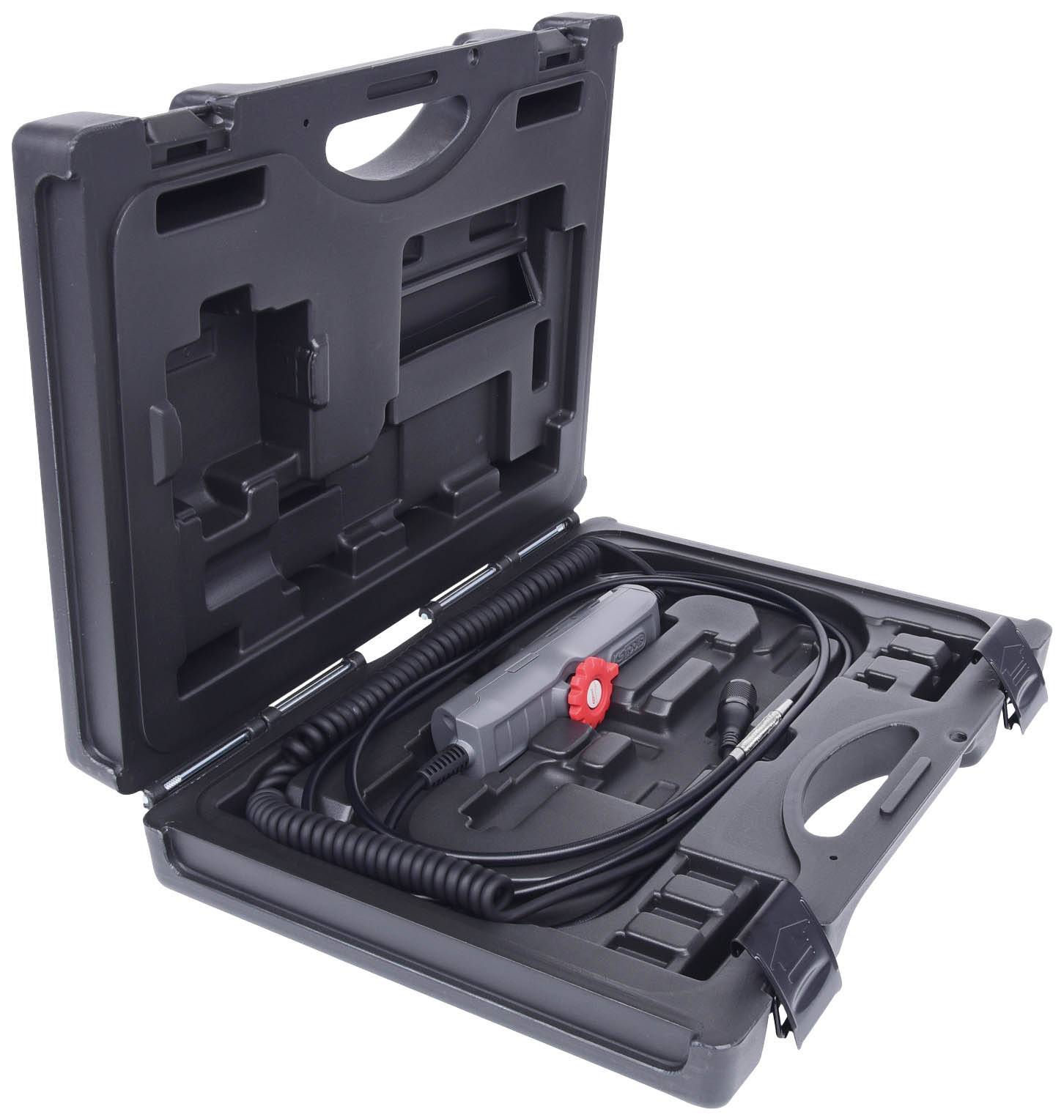 A black plastic case with an open lid reveals an electric tool set, comprising cables and a handheld device with a red switch.