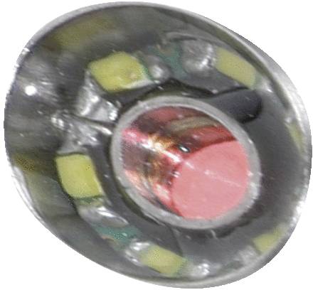 Close-up of an LED with a red light source and yellow elements, surrounded by a silver casing.