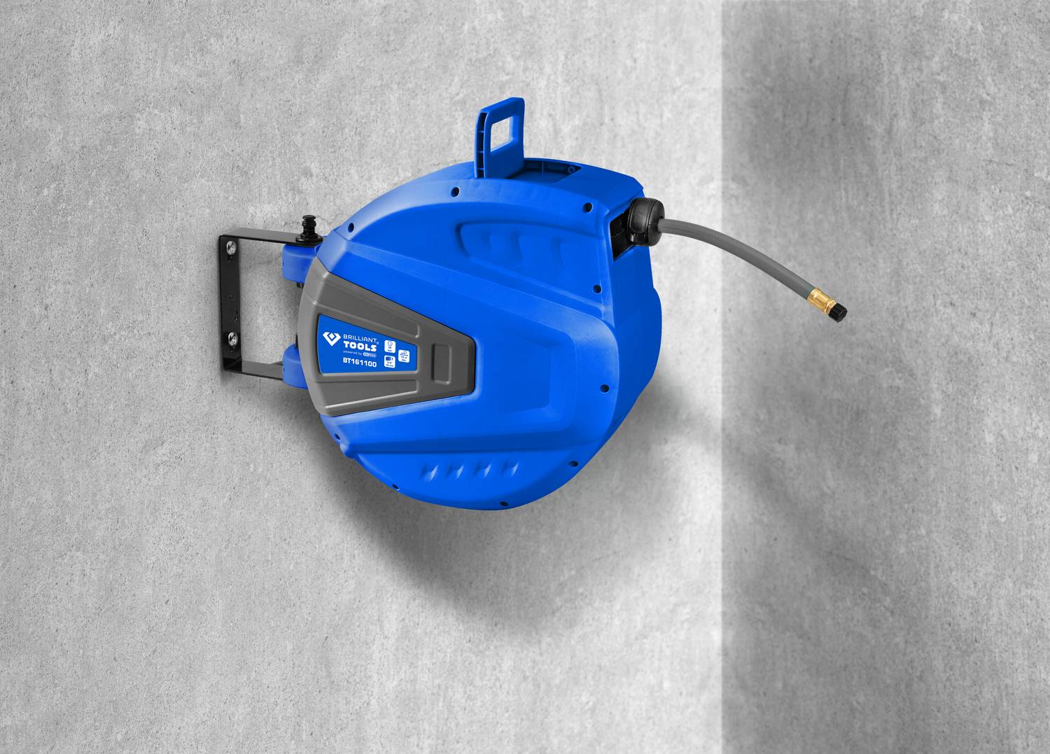 A blue automatic hose reel is mounted on a grey wall. A short hose protrudes from the reel.