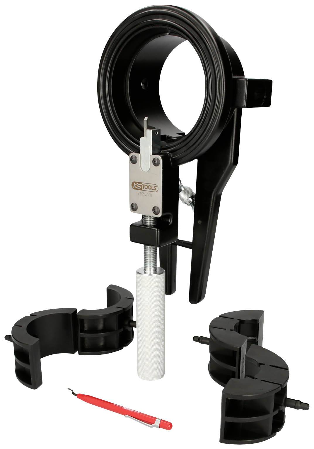 Coil spring compressor with various attachments and a red tool. Used for installing and removing suspension struts.