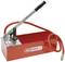 Red pressure testing hand pump by KS Tools with pressure gauge and hoses, used for pressure testing in plumbing and heating systems.