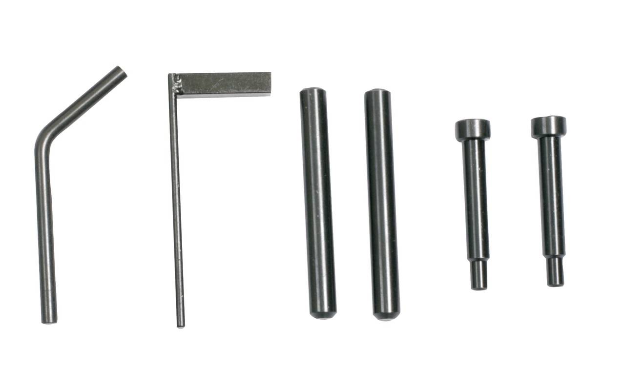 Several metal posts and tools on a light background, arranged in a row. Tools suitable for assembly or repair.