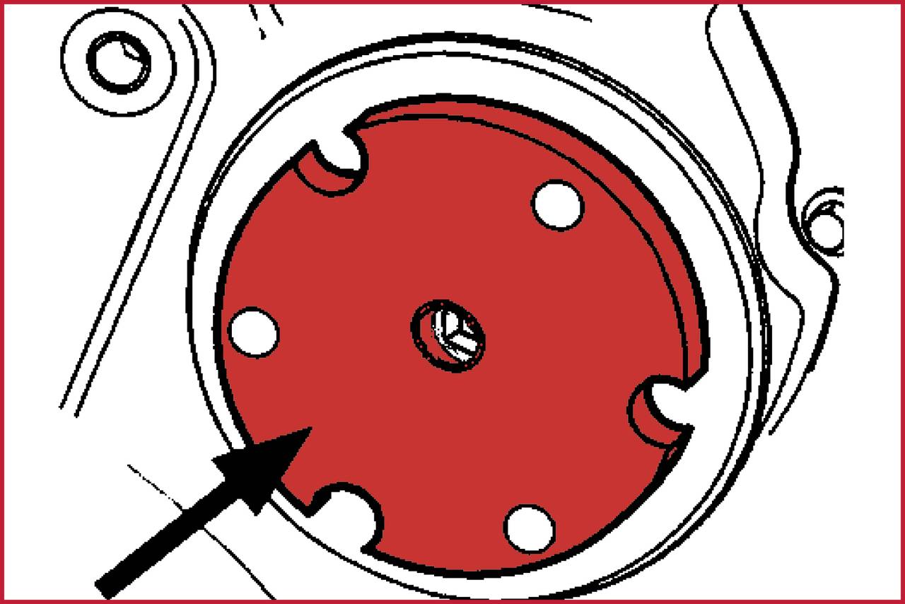 Diagram of a red-marked cover with four small white points and a central hole, with an arrow pointing to it.