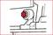 Figure of a red nut head on a machine. The nut head is located on a stationary component.