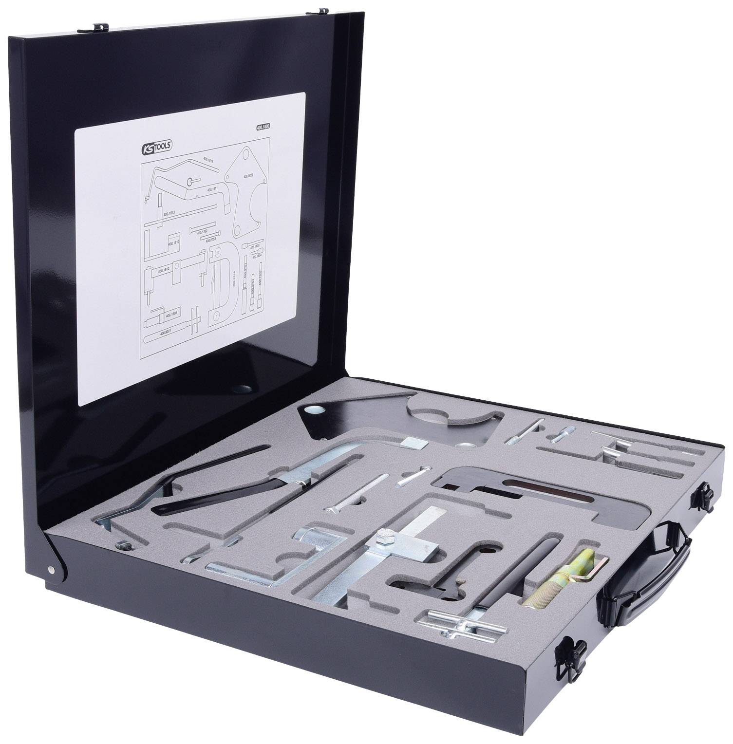 Metal case with an open lid, filled with custom tools and a foam insert. An instruction manual is visible inside.